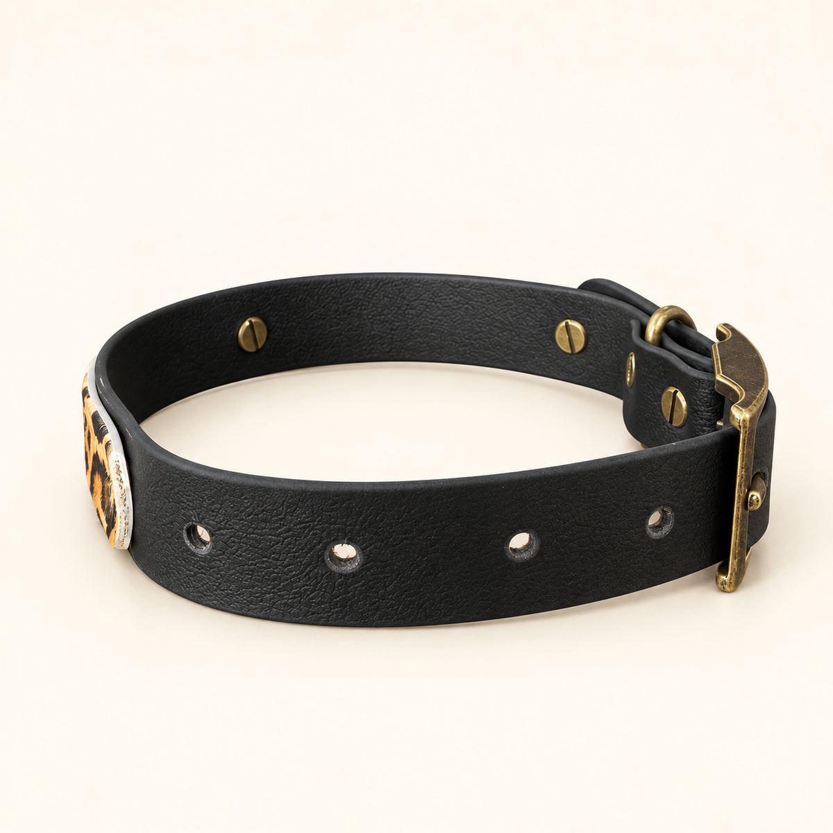 The Wild One leopard print dog collar showing black BioThane lining and antique hardware